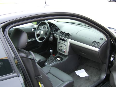 1998 Ford Taurus - Interior view of a car, black leather seats and a silver-accented dashboard.
