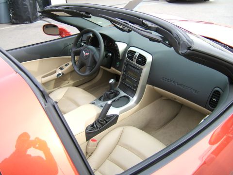 1998 Ford Taurus - The interior of a convertible shows tan leather seats and the dashboard with 'CORVETTE' embossed on it.