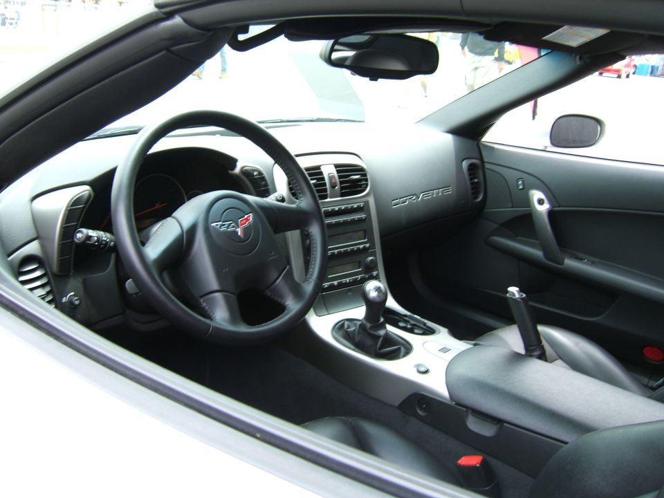Corvette interior with black leather seats, silver trim, and a manual shifter