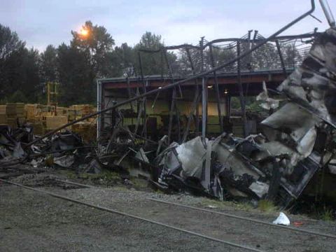 1995 Ford Bronco - Scene of a destroyed building with debris and train tracks visible.