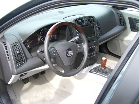 1998 Ford Taurus - Interior view of a Cadillac showing the steering wheel, dashboard, and center console.