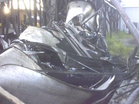 1995 Ford Bronco - The interior of a vehicle is heavily damaged and appears to have been exposed to fire.