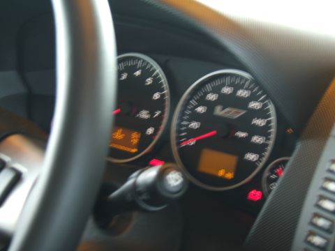 1998 Ford Taurus - Interior view of dashboard gauges, including a speedometer marked up to 160 mph and a V-series emblem.