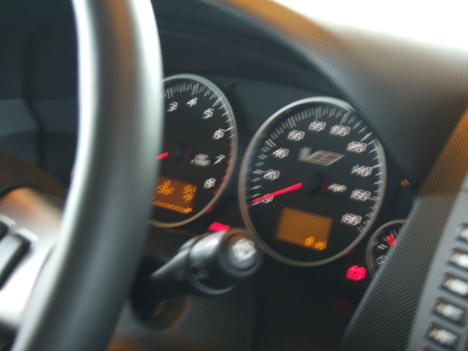 Dashboard gauges with V-series logo, speedometer reads 80 mph