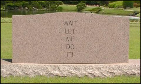 1976 Ford F-150 - A stone monument with engraved text stands in a park with a pond and trees in the background.