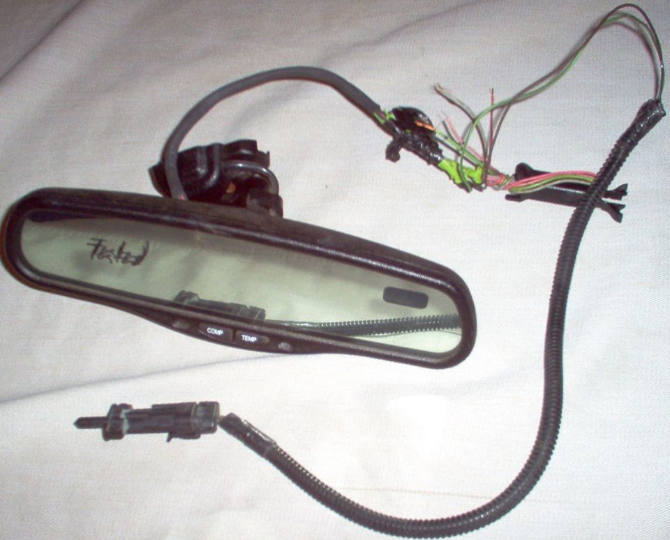 AutoDimming Rear View Mirror with compass & temperature. Includes mounting button, wire cover, temperature sensor, and ~1' of wire on each connector. Tested, and has no noticeable scratches on glass or housing.