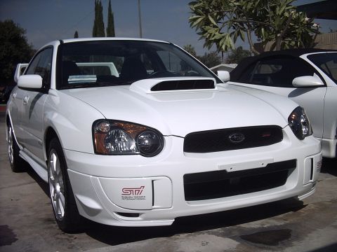 2005 Subaru Impreza - Front view of a white 2005 Subaru Impreza WRX STI parked next to another white car.