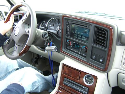 1998 Ford Taurus - Interior of a car showing the dashboard, steering wheel, and center console with wood accents.