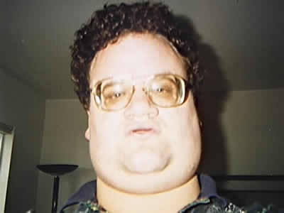 1986 Ford Bronco - A man with glasses and curly hair is pictured indoors.