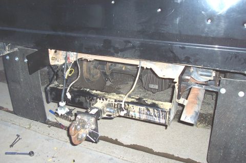 1994 Ford F-150 - Rear view of a truck bumper and trailer hitch assembly, showing exposed wiring and a tow ball.
