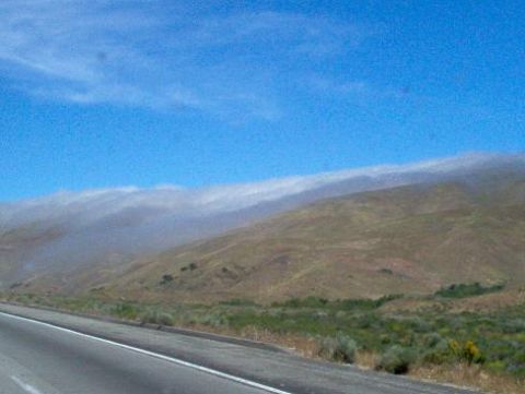 1988 Ford Bronco - Hills and fog seen from the side of a road on a clear day.