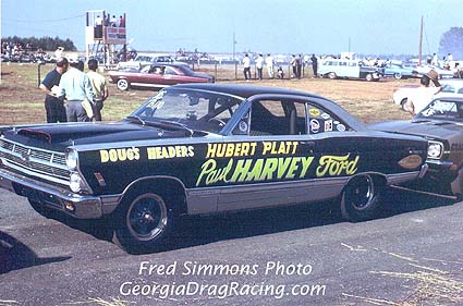 1967 Ford Fairlane - 1967 Ford Fairlane drag car with custom lettering on the side, parked at a drag strip.