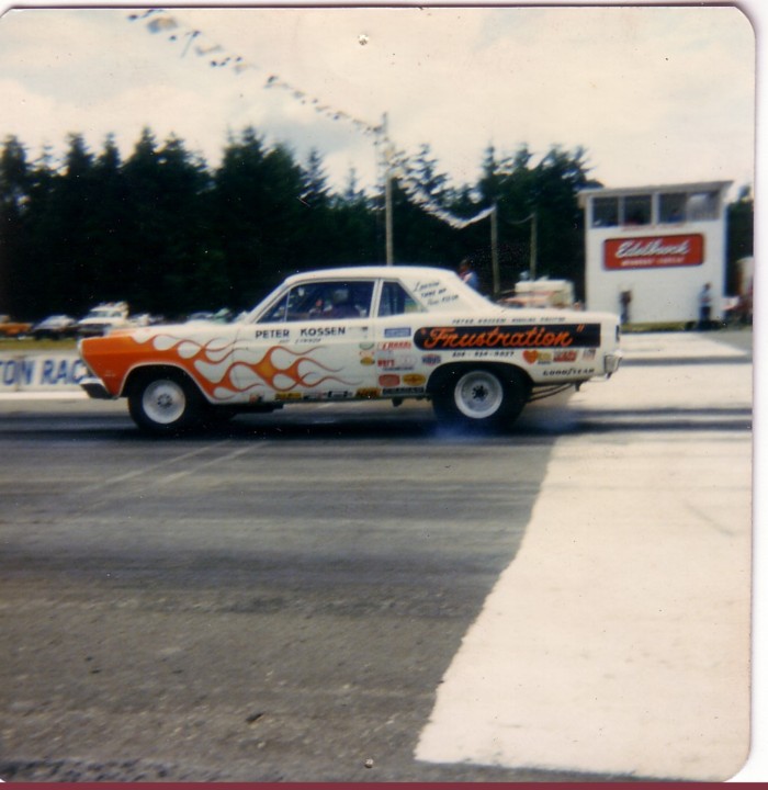 White drag coupe with flame graphics reading 'Frustration' launching on a track
