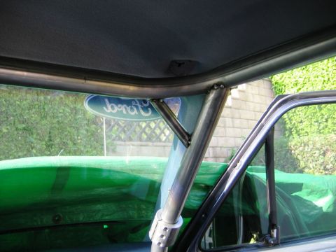 1985 Ford Bronco - A custom roll cage is installed inside a vehicle, with a Ford emblem visible in the background.
