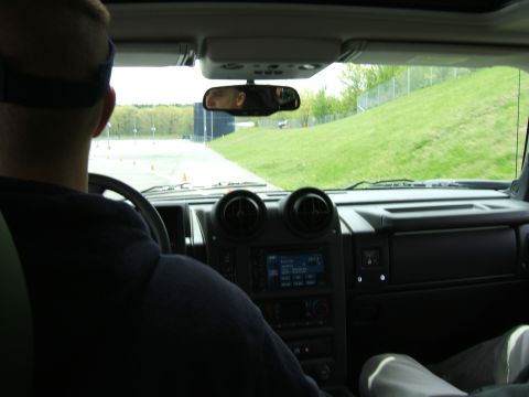 1998 Ford Taurus - The interior of a Hummer H2 is shown from the passenger seat, looking towards the dashboard and driver.