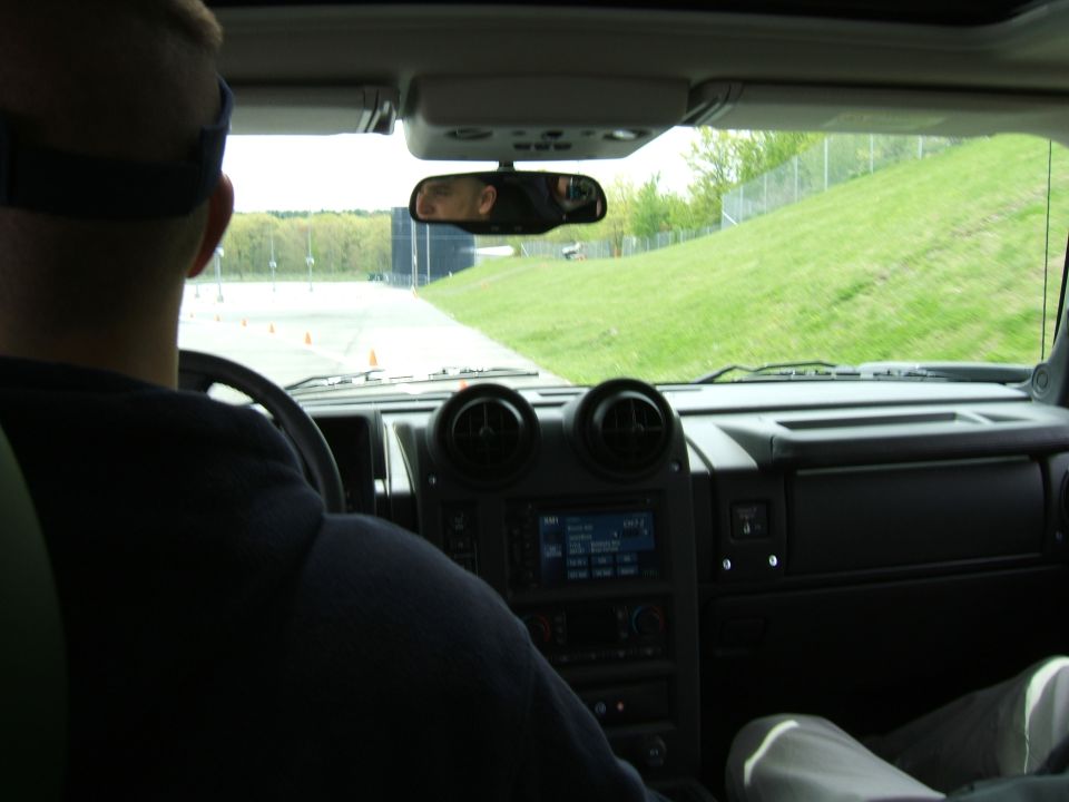 Interior view of a Hummer H2 with a driver and dashboard visible