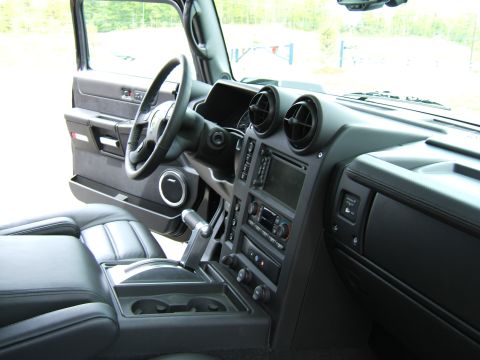 1998 Ford Taurus - Interior view from the passenger side of a black SUV, showing the steering wheel, center console with column-mounted shifter, dashboard air…