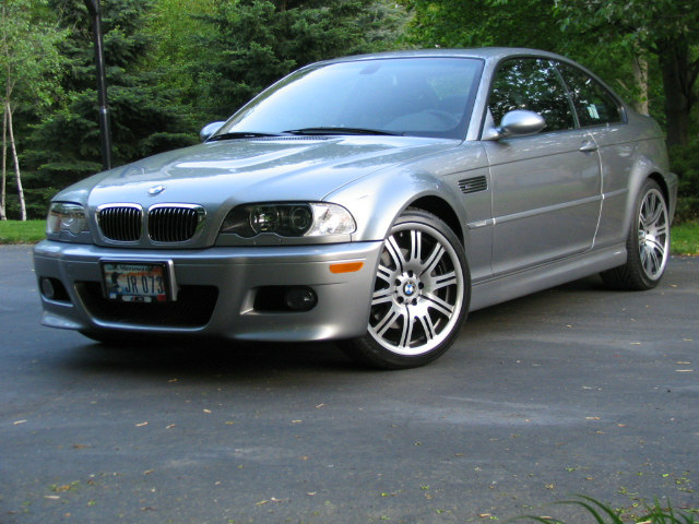 Silver BMW E46 M3 coupe parked on driveway, front three-quarter view