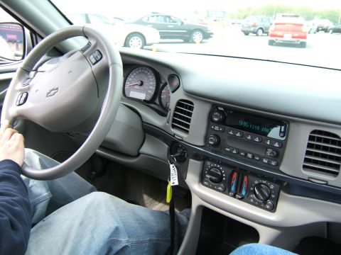 1998 Ford Taurus - Interior view of a car's dashboard, showing the steering wheel, instrument cluster, and radio display.