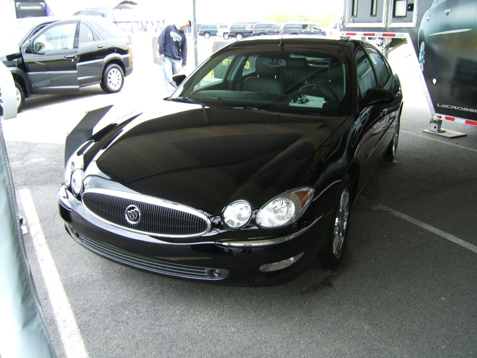 Black Buick sedan front 3/4 view. Buick logo on grille