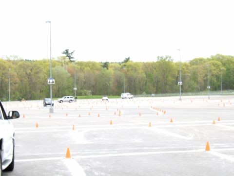 1998 Ford Taurus - A parking lot is set up with traffic cones, and multiple vehicles are present in the background.