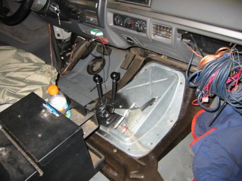 1992 Ford Bronco - The interior of a 1992 Ford Bronco, dual shifters and a significant amount of exposed wiring.