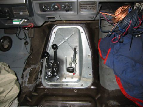 1992 Ford Bronco - Vehicle interior showing the center console area with dual shifters and wiring.