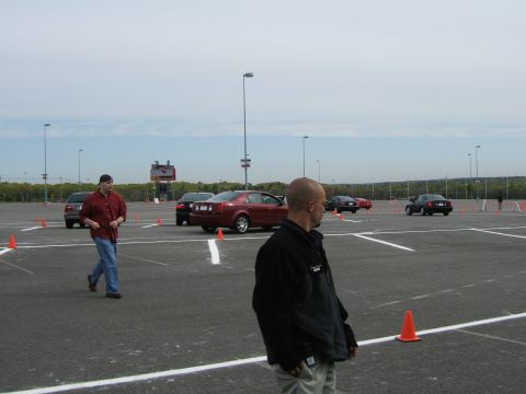 1998 Ford Taurus - Cars are set up in a parking lot with cones, possibly for an event or training.