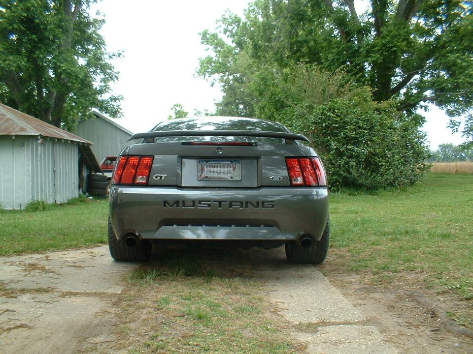 Gray Ford Mustang GT rear view with a spoiler and GT badge