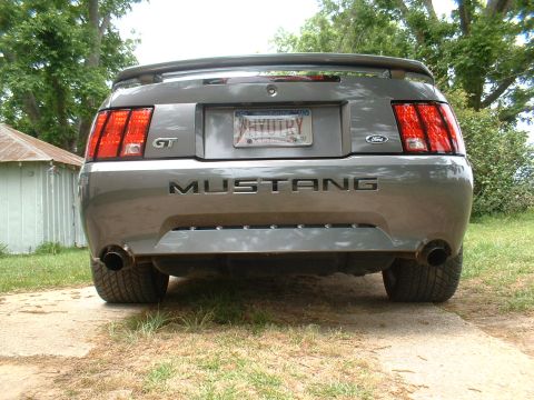 2003 Ford Mustang - This 2003 Ford Mustang GT is shown from the rear, its distinctive taillights and 'MUSTANG' lettering on the trunk.