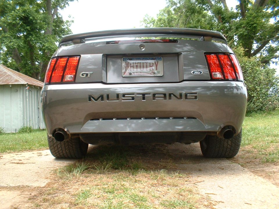 Rear view of a grey 2003 Ford Mustang GT with 'MUSTANG' badging