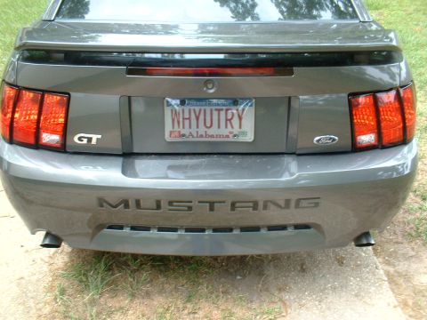 2003 Ford Mustang - Rear view of a gray 2003 Ford Mustang GT, showing the GT and Mustang badging.