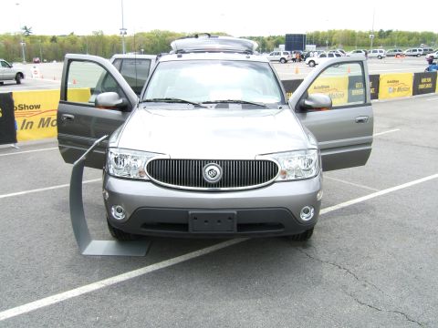 1998 Ford Taurus - A gray Buick Rendezvous is displayed with its doors open at an outdoor event.