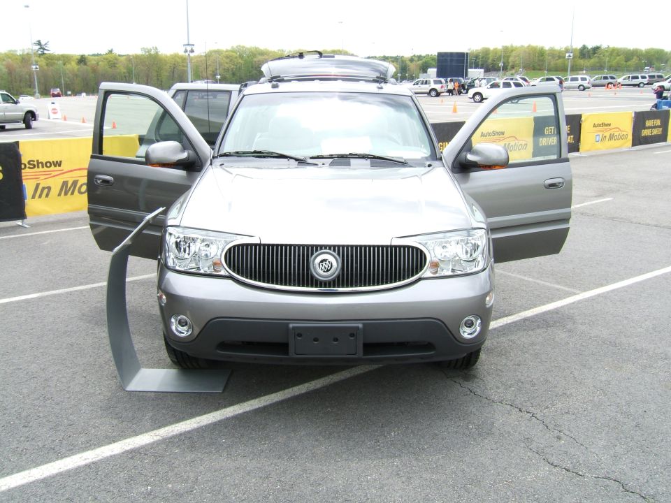 Gray Buick Rendezvous with doors open, front view, parked on asphalt