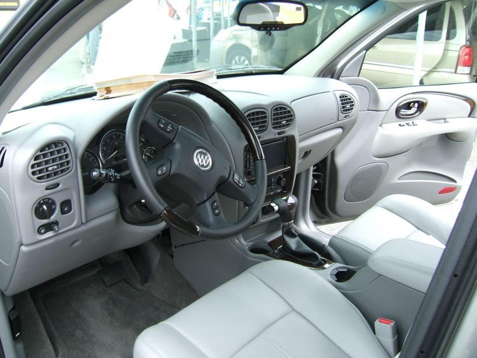 Gray interior with Buick logo on steering wheel, dashboard, and light gray seats