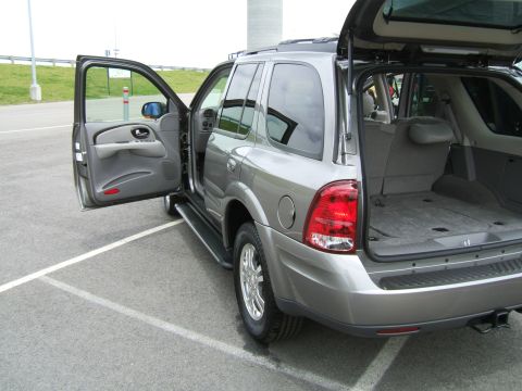 1998 Ford Taurus - This silver SUV has its driver's side door and rear cargo area open, revealing the interior and trunk space.