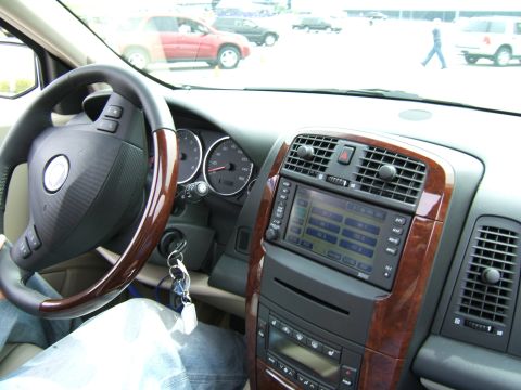 1998 Ford Taurus - Interior view of a car's dashboard and steering wheel, with other vehicles seen through the windshield.