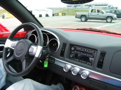 1998 Ford Taurus - Interior view of a red car with a grey pickup truck in the background.