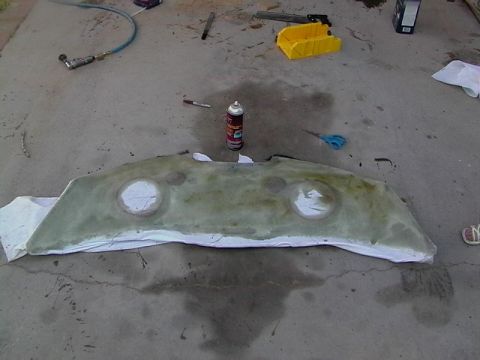 1999 Ford Taurus - A custom fiberglass part, possibly for a car, is laid out on a concrete surface with various tools around it.
