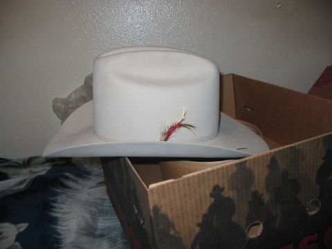 1986 Ford Bronco - A cowboy hat sits on top of a cardboard box with a graphic of cowboys on horseback.