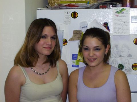 1997 Ford Taurus - Two young women stand in front of a refrigerator adorned with various notes, drawings, and magnets.
