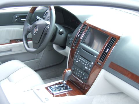 1998 Ford Taurus - Interior view of a car's dashboard, steering wheel, and center console with wood trim.