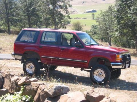 1991 Ford Explorer - This lifted 1991 Ford Explorer is ready for adventure, parked in a scenic rural setting.