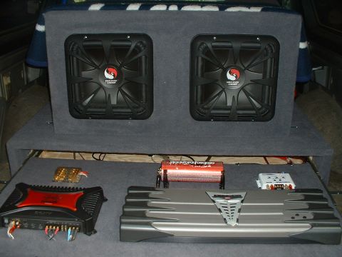 1989 Ford Bronco - Car interior with audio equipment including subwoofers and amplifiers.