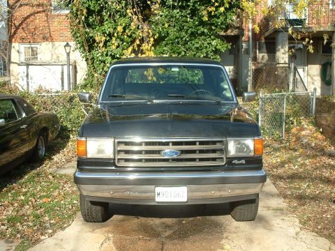 1989 Ford Bronco - Front view of a black 1989 Ford Bronco parked on a driveway.