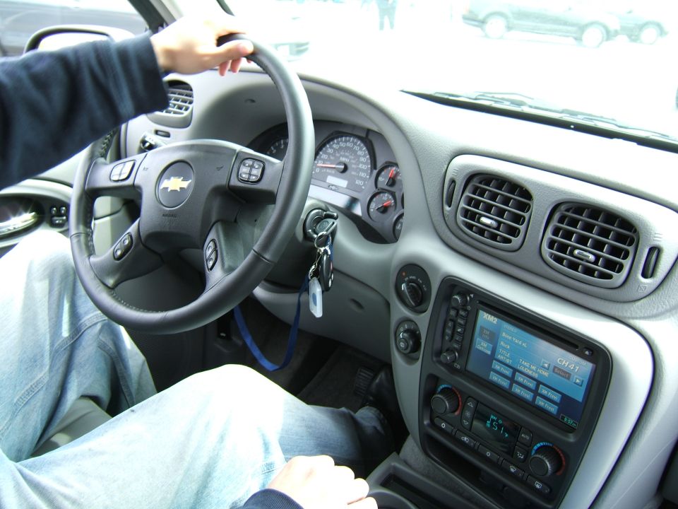 Interior view of a Chevrolet Trailblazer showing the steering wheel, dashboard, and radio