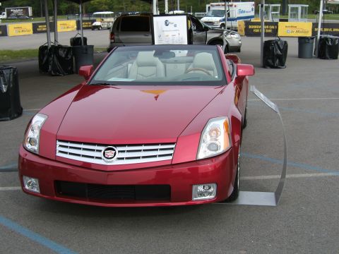 1998 Ford Taurus - A red convertible with a tan interior is parked on pavement, viewed from the front.