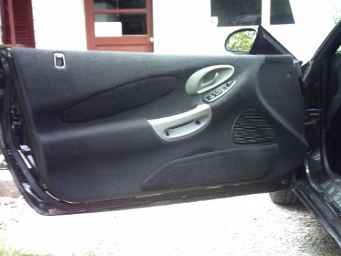 1995 Ford Probe - Interior view of a car door, showing the panel, handle, and speaker grille.