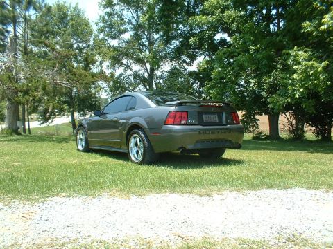 2003 Ford Mustang - Rear view of a gray 2003 Ford Mustang GT with aftermarket wheels.