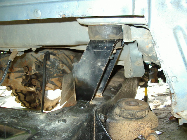 Undercarriage of a vehicle showing a transfer case and suspension components